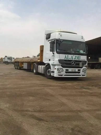 Al-Ajmi white Mercedes Actros and low-bed trailer